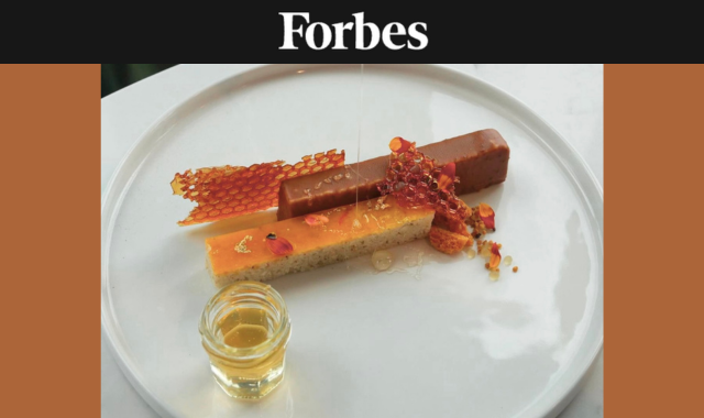 Beauty shot of The Wilde's honey dessert—pastry elements with honeycomb and honey drizzled on top