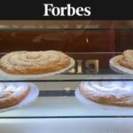 Ensaimada pastries on bakery shelves